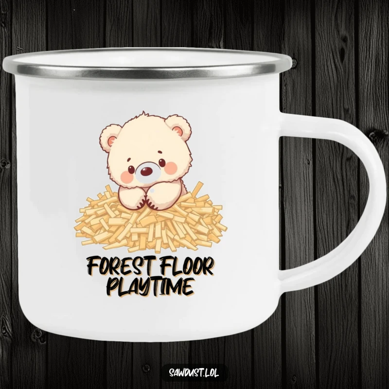 Funny enamel camping mug showing a cute, fluffy bear cub playing happily in a pile of wood shavings.